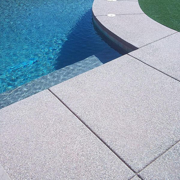 Untitled Backyard concrete firepit with concrete planters and bench.
